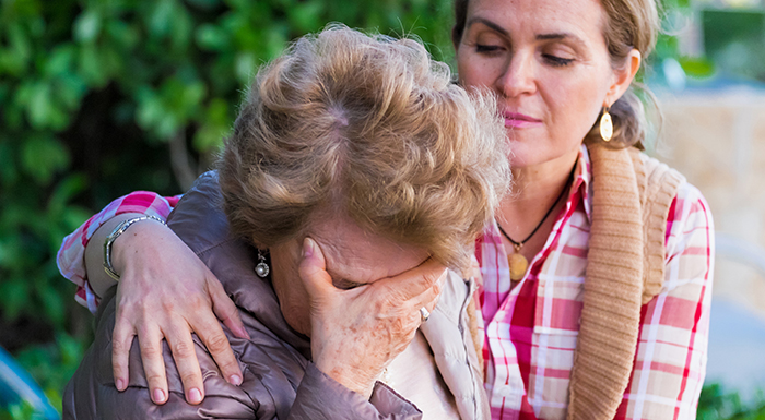 Picture of a young woman consoling an older woman